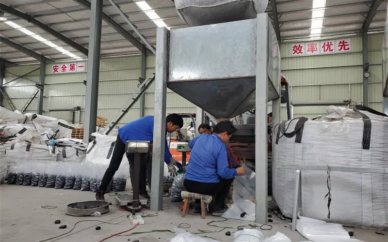 Industrial machinery for tumbling and polishing natural pebbles and glass media.