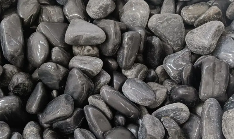 Low Quality Polished Black Pebbles used in outdoor landscaping projects