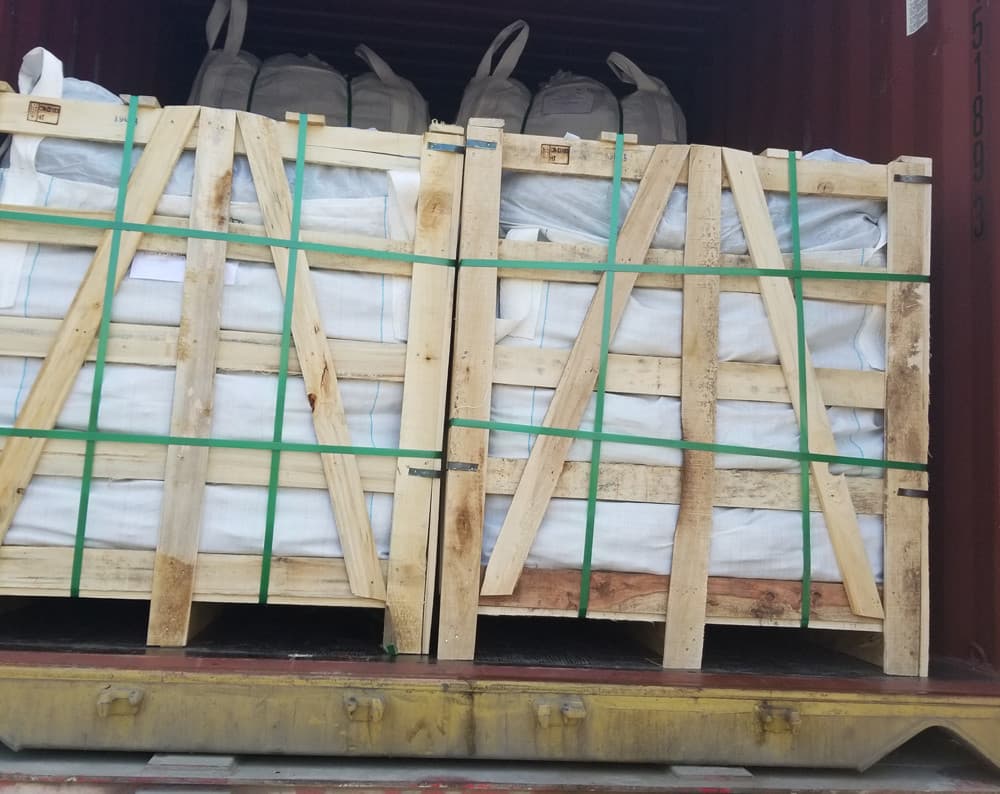Sturdy wooden crates loaded with landscaping stones, neatly stacked to prevent cargo damage during international B2B container shipping.